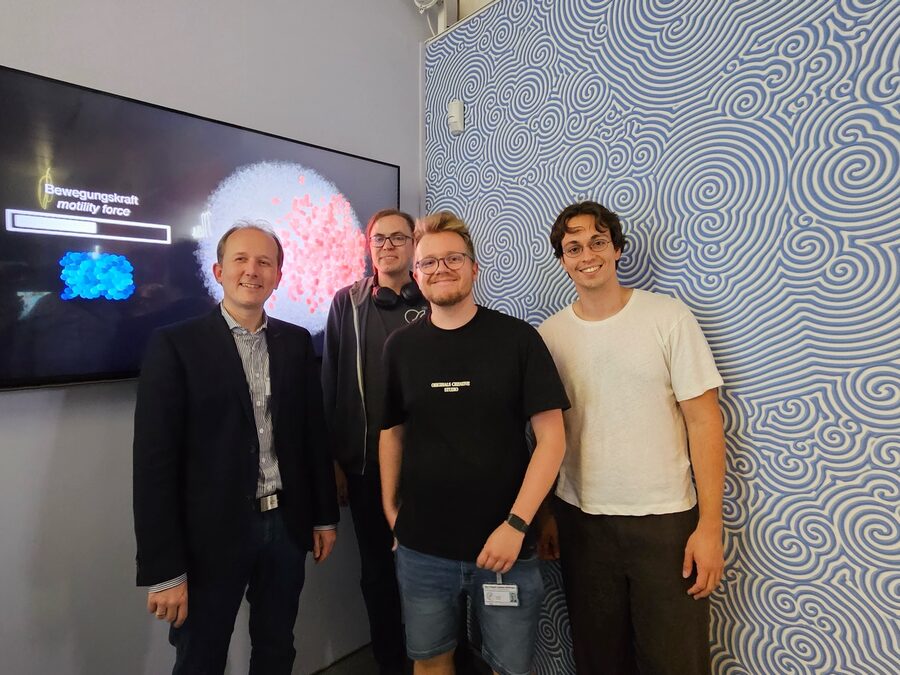 Members of the group in front of the interactive 3D visualization exhibit at the Forum Wissen museum
